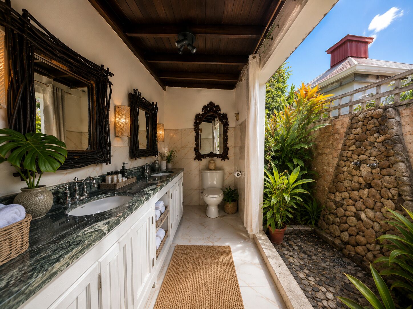 A bathroom with a marble sink, multiple mirrors, a toilet, and a stone wall.