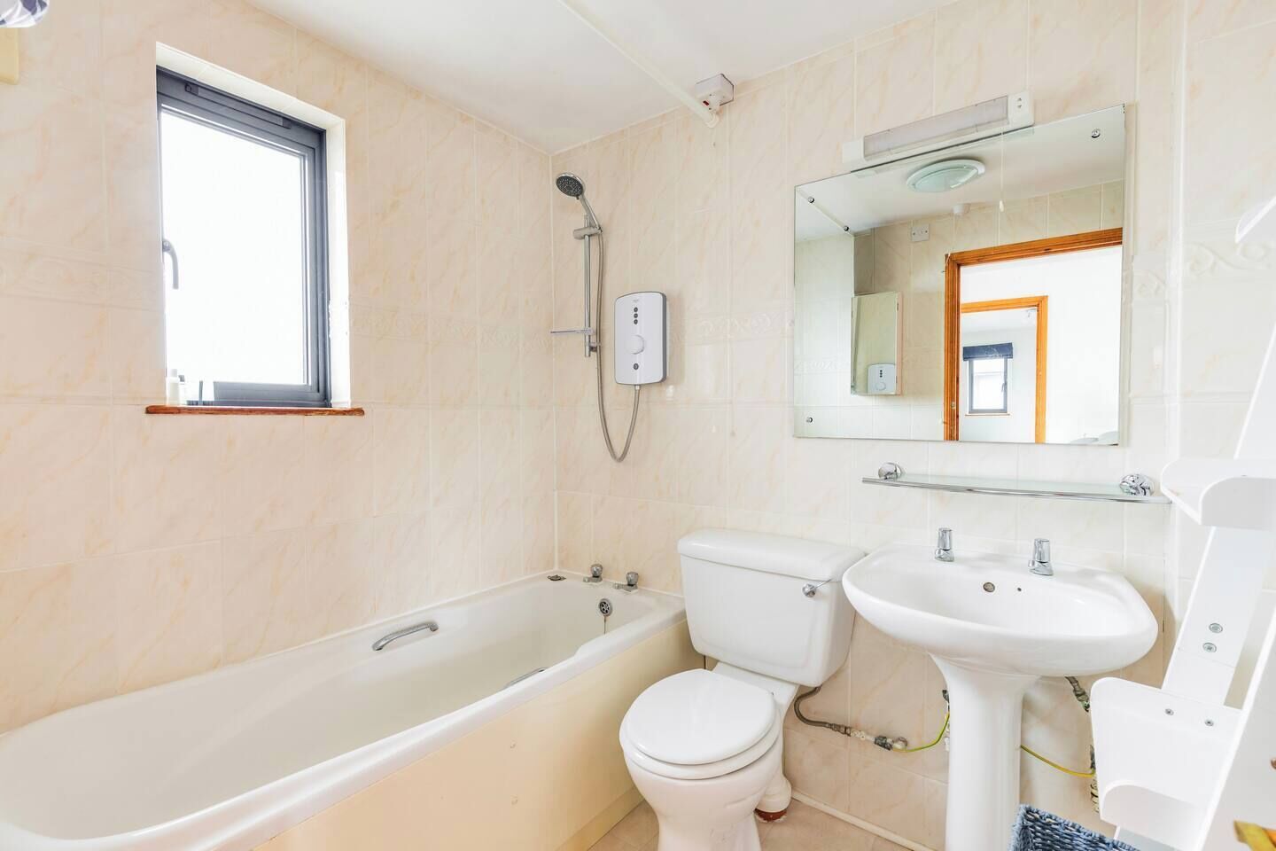 A bathroom with a bathtub, toilet, and sink.