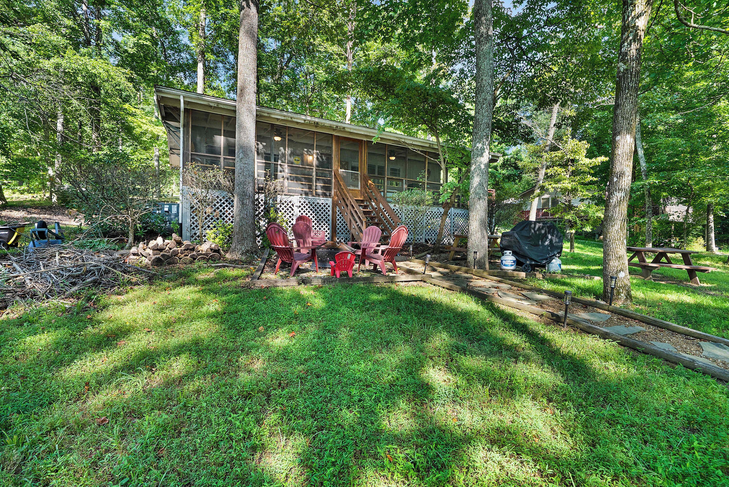 A house with a covered porch, a wooden deck, and a picnic table.