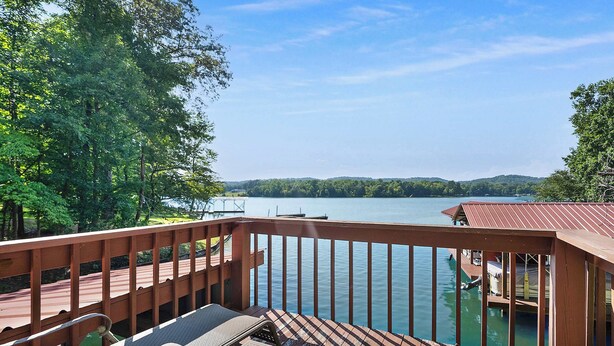 A wooden deck with a view of a lake and dock. - Lakefront Cabin on Watts Bar Lake | Private Dock & Views (Roane County)