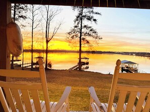 Two wooden chairs facing a lakeside view with a gazebo and dock. - Waterfront! Prime Location, Clean, Swimming Pool, Fishing Dock, WIFI (George town)