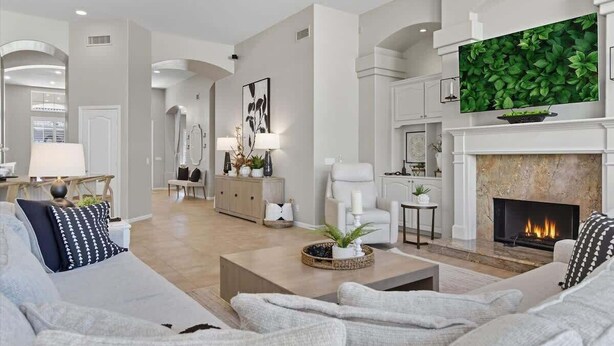 A modern living room with a fireplace, a television, and a dining area. - Sol - Pool & Hot Tub - Mins to TPC Scottsdale (Scottsdale)
