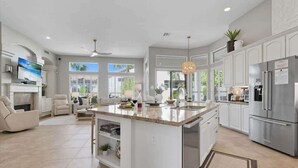 A modern kitchen with a central island, white cabinetry, and stainless steel appliances. - Sol - Pool & Hot Tub - Mins to TPC Scottsdale (Scottsdale)