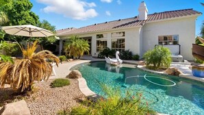 A house with a swimming pool, a swan float, and a patio umbrella. - Sol - Pool & Hot Tub - Mins to TPC Scottsdale (Scottsdale)