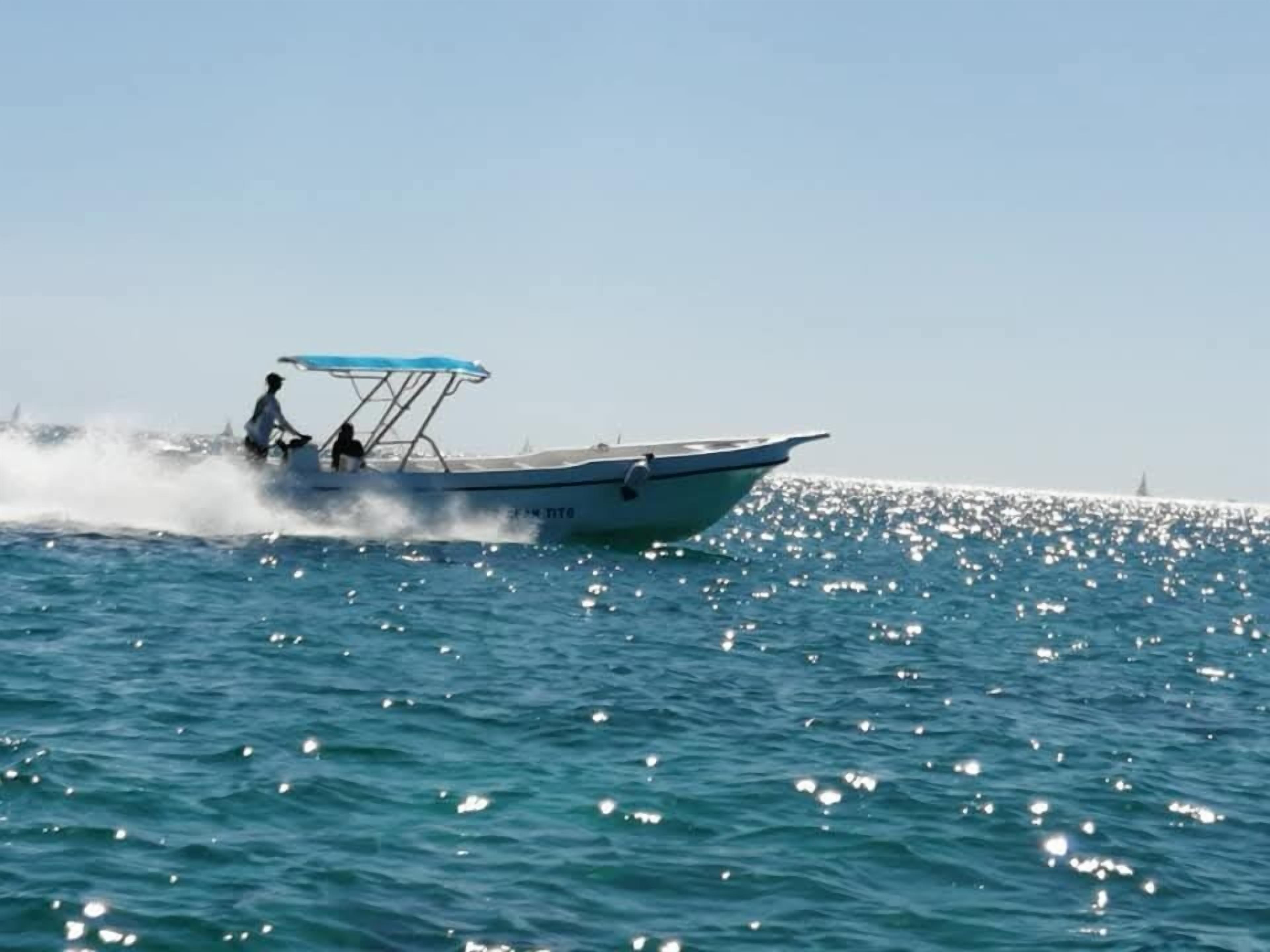 A boat on a calm sea with a clear sky.