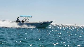 A boat on a calm sea with a clear sky.