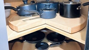 A kitchen with multiple black pots and pans on wooden shelves. - Luxurious 3-bedroom 2 bath near NYC train station, EWR. (Newark)