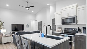 A modern kitchen with a central island, a built-in oven, and a microwave. - Beautiful & Spacious 3BR Retreat | Clean, Quiet, Sleeps 8 (Idaho Falls)