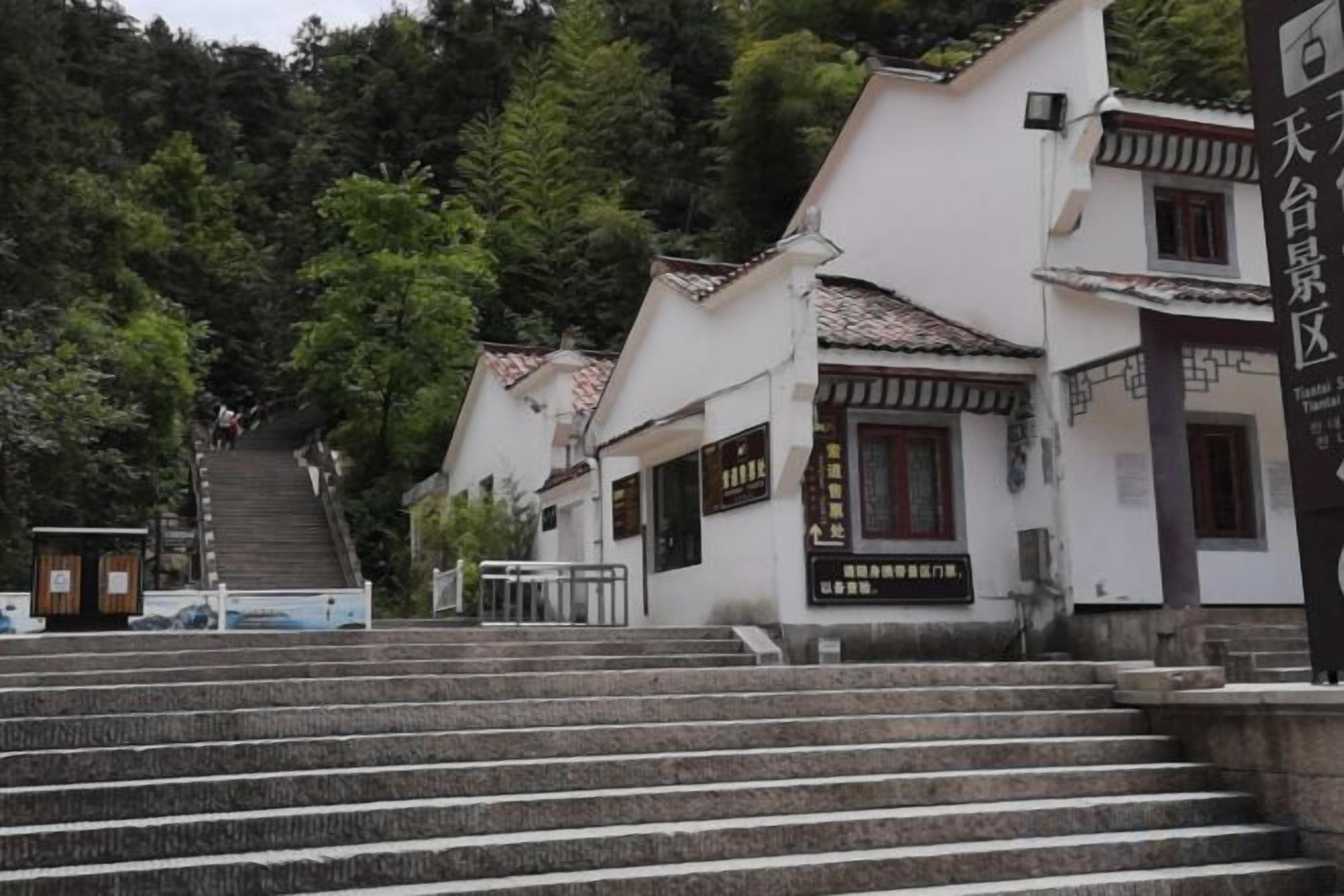 A traditional Japanese building with a staircase leading up to the entrance.