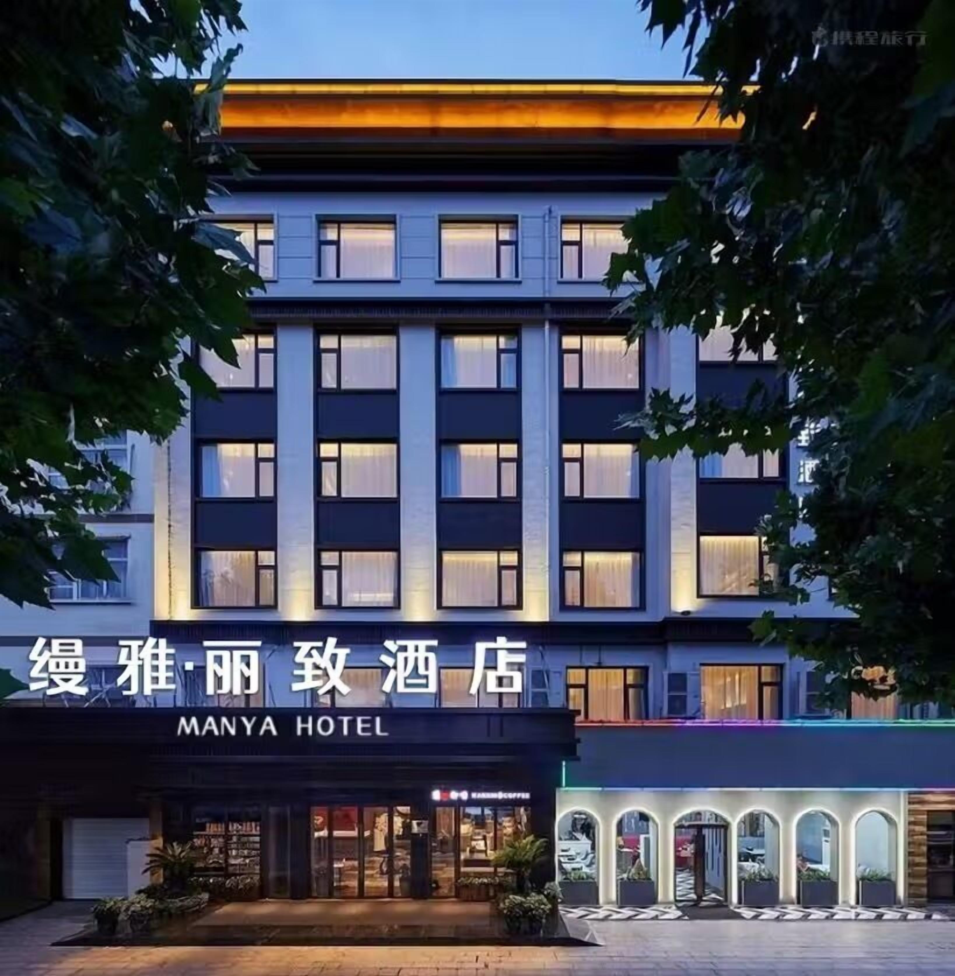 A modern hotel building with a sign reading "MANYA HOTEL".