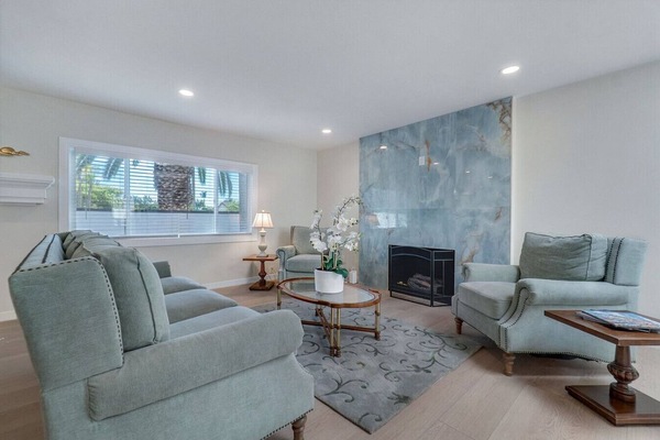 Bright living area with stylish fireplace and seating.