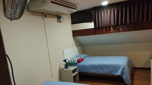 A room with two beds, a nightstand, an air conditioning unit, and a window with curtains. - Charming 1-bedroom apartment in Surco with AC, two blocks from American Embassy (Santiago de Surco)