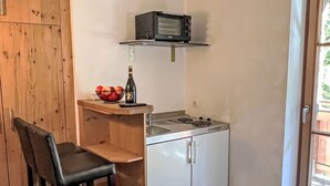 A compact kitchenette with a microwave, a sink, and a small countertop. - Apartment Studio by Interhome (Oberndorf in Tirol)