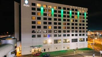 A multi-story hotel with a prominent 'Sofitel' sign, featuring a grid of windows and a flat facade.