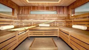 A sauna with wooden benches and a skylight ceiling. - Sheraton Grand Hotel & Spa, Edinburgh (Edinburgh)