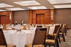 A banquet hall with round tables, chairs, and a central buffet area. - Sheraton Grand Hotel & Spa (Edinburgh)
