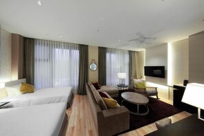 A hotel room with two beds, a sofa, a small table, a TV, and a ceiling fan. - Solaria Nishitetsu Hotel Seoul Myeongdong (Seoul)