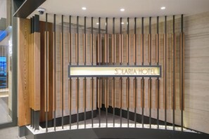 A reception area with a sign for Solaria Hotel, featuring vertical wooden slats and a modern design. - Solaria Nishitetsu Hotel Seoul Myeongdong (Seoul)