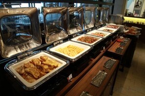 A buffet with various food items in trays, including what appears to be fried chicken, French fries, and other dishes. - Solaria Nishitetsu Hotel Seoul Myeongdong (Seoul)