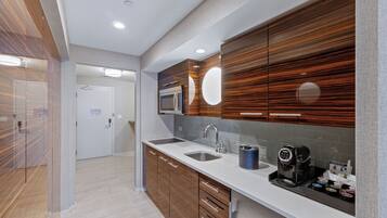 A modern kitchen with a double sink, stainless steel appliances, and wooden cabinetry.