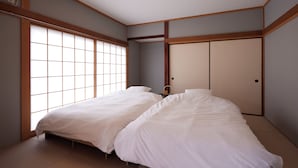 A traditional Japanese-style bedroom with two beds, sliding doors, and a ceiling light. - rinne 2nd living Nasu Creek (Nasu)