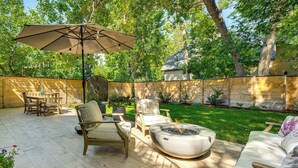 A patio with outdoor furniture, a fire pit, and a large umbrella. - Downtown Walkability - 'The Purple House' (Berthoud)