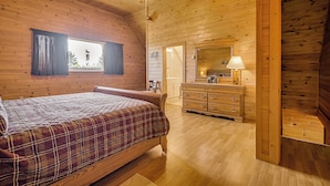 A wooden cabin bedroom with a bed, dresser, and ceiling fan. - Mountain-View Deck! Cabin By Mt Abraham Trails (Salem Township)