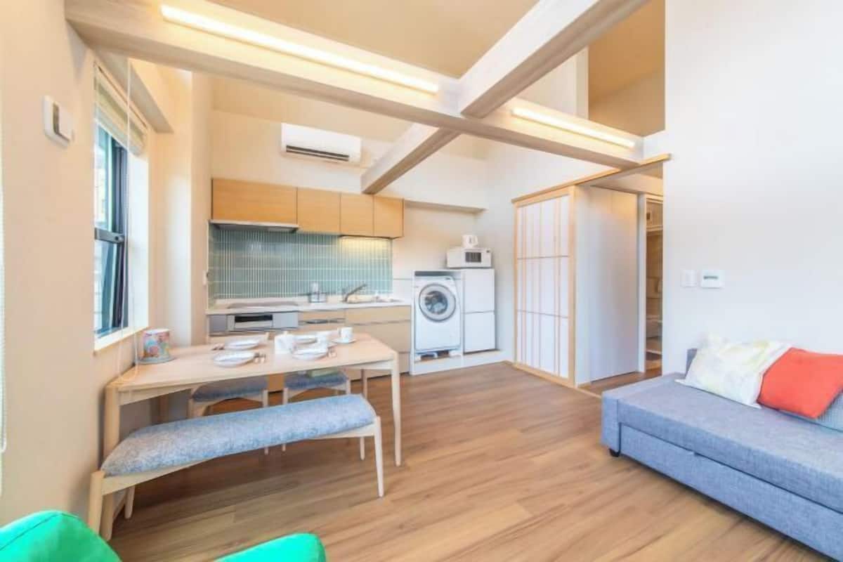 A compact living space with a kitchenette, a dining area, and a seating area.