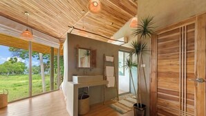 A modern bathroom with a wooden ceiling, large windows, and a sink. - Carbana Lodge, 2 Bedrooms - Eco Lodge, Koh Samui (Koh Samui)
