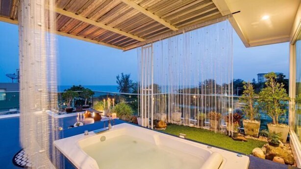 A rooftop infinity pool with a hot tub, surrounded by potted plants and a view of the ocean. - Olivia Beach Sea and Sky Pool Villa Hua Hin (Cha-am)