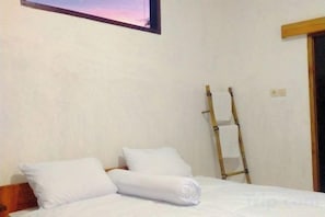 A single bed with white bedding and pillows, a wooden ladder leaning against the wall, and a window with a view of the sky. - Billi Family (Aik Berik)