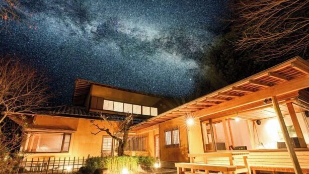 A traditional Japanese house with a wooden exterior, large windows, and a stone pathway leading to the entrance. - KEYAKIZAKA (Ito)