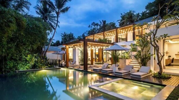 A modern resort with a pool, outdoor seating, and lush greenery. - Villa Oasis by BaliSuperHost (Bali)