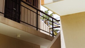 A multi-level interior with a staircase, metal railings, and a view of palm trees outside. - Samba Ahangama (Ahangama)