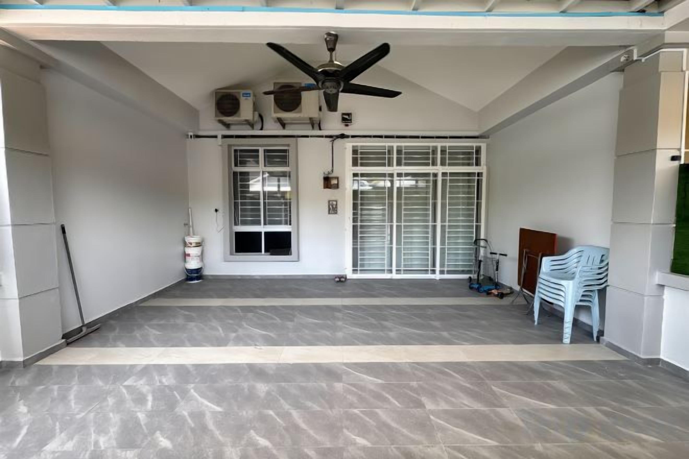 A covered outdoor area with a ceiling fan, air conditioning units, a door with a window, and a white plastic chair.