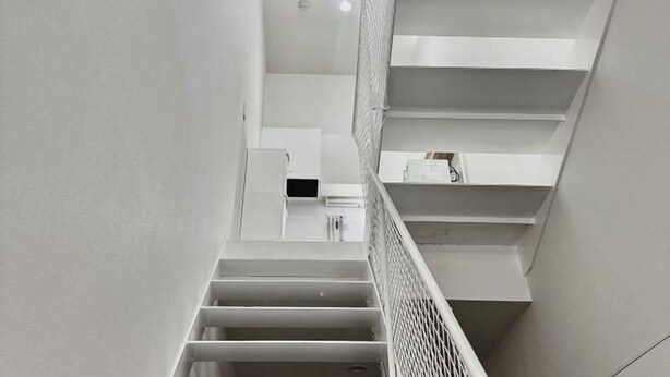 A modern staircase with white walls and a metal railing. - Only 10 minutes by train to Asakusa & Skytree! (Tokyo)