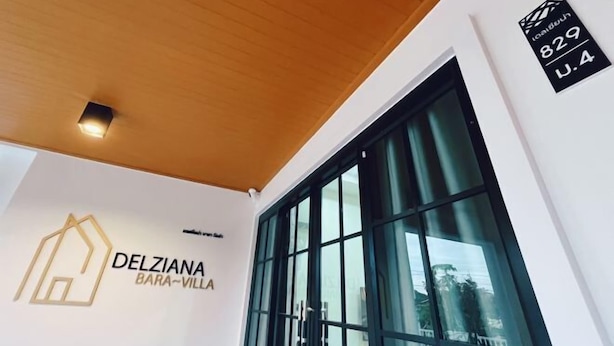 A modern building with a large window, a sign reading "DELZIANA BARA-VILLA", and a plaque with the number "829 U.4". - DelZiaNa Bara Villa Pakbara Satun (La-ngu)