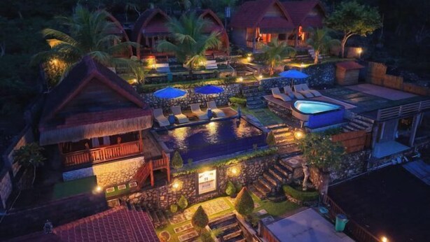 A resort with multiple overwater bungalows, a swimming pool, and outdoor seating areas. - Sebuluh Sunset Hill (Bali)