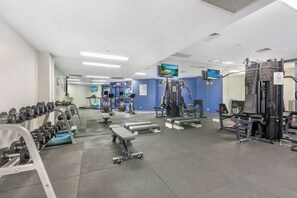 A gym with various exercise equipment, including dumbbells, benches, and weight machines. - Arcade in the Sky - Views, Games & Vibes (Brisbane)