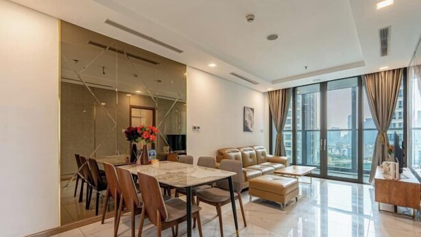 A modern living room with a dining area, large windows, and a view of the city. - Stellar Landmark 81 Apartment (Ho Chi Minh City)