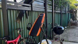A red bicycle, a folding chair, and a barbecue grill in an outdoor setting. - Sweet home (Concord West)