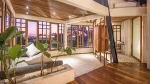 A spacious room with large windows, a wooden ceiling, and a view of the outdoors. - BAz Penthouse (Bali)