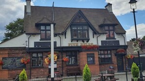A traditional pub with a white facade, black trim, and a sign reading "FIVE BEARS." - Min Su Rooms (Stanwell)