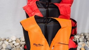 A life jacket with the text "Play House Pool Villa" on it. - Baba beach (Pattaya)
