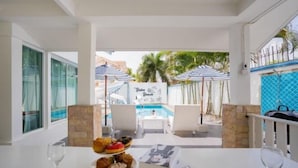 A dining area with a pool view, outdoor seating, and a menu. - Baba beach (Pattaya)