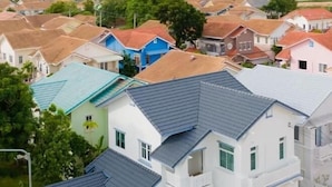 A residential area with multiple houses, some with balconies and others with flat roofs. - Baba beach (Pattaya)