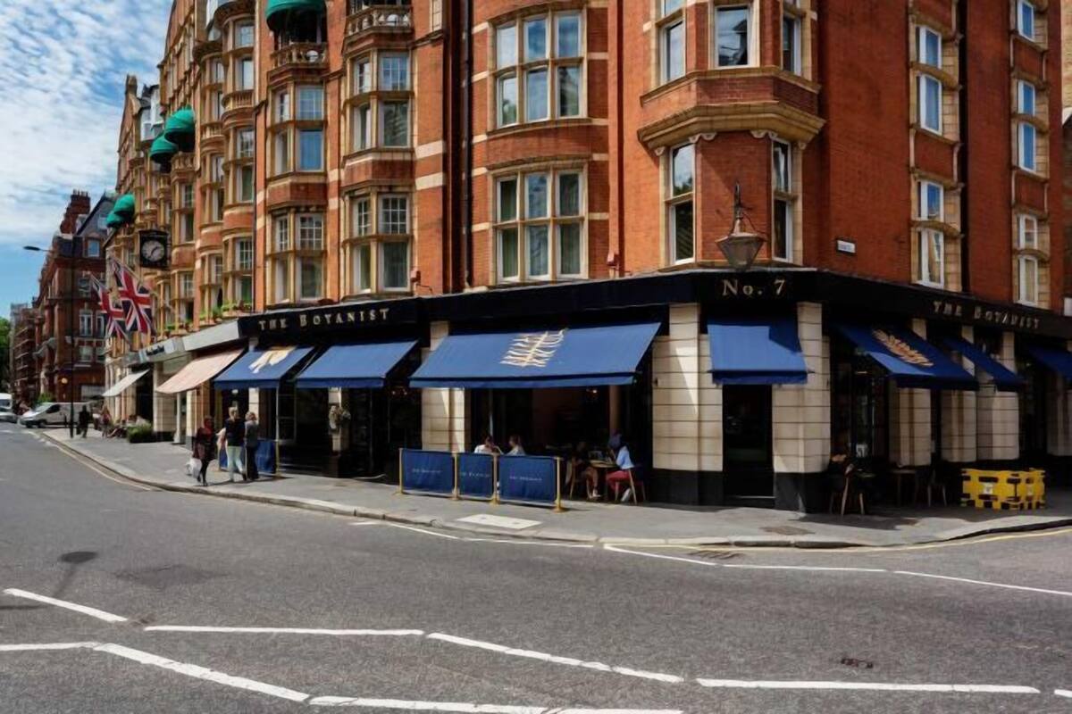 A corner building with a pub named "The Botanist" on the ground floor.
