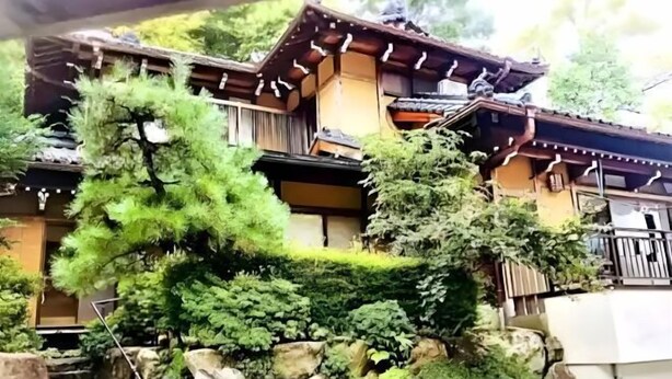A traditional Japanese-style building with a wooden exterior, stone steps, and lush greenery. - Private Villa Gifu Takayama (Takayama)