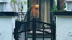 A black metal gate with a decorative design, leading to a staircase. - Chakk 109 Mussoorie Foothills, Dehradun (Dehradun)