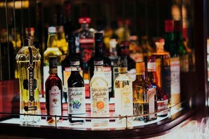 A variety of liquor bottles displayed in a bar setting. - Erykah Hotel Mityana Road (Mawokota)